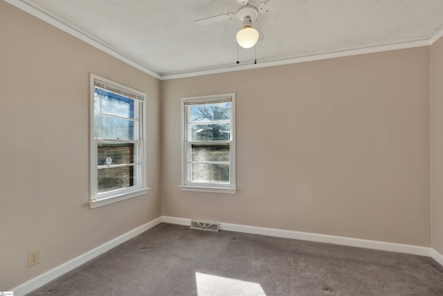 carpeted spare room featuring a textured ceiling, ceiling fan, and crown molding