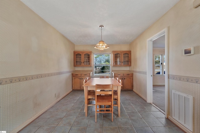 tiled dining space with a notable chandelier