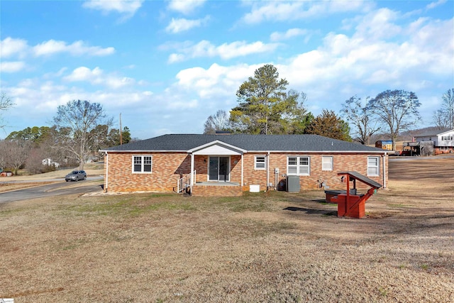 ranch-style home featuring central AC and a front lawn