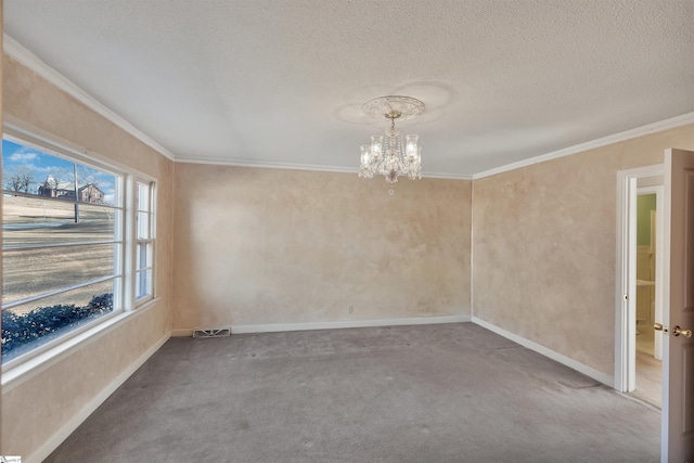 unfurnished room with an inviting chandelier, ornamental molding, a textured ceiling, and carpet floors