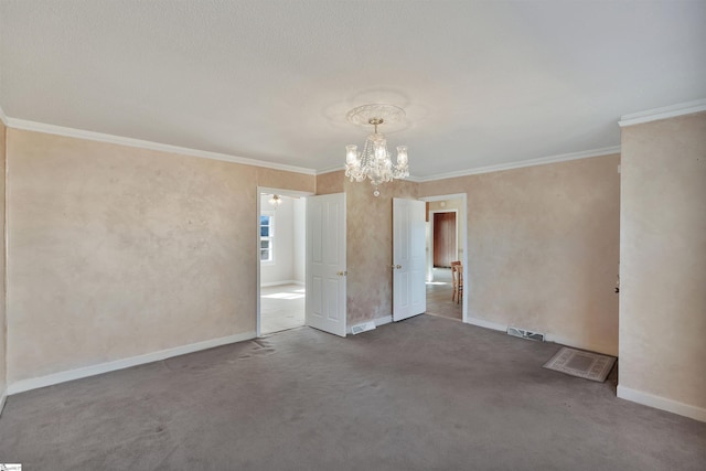 carpeted empty room featuring ornamental molding and an inviting chandelier