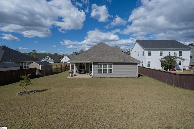 rear view of property featuring a patio area and a yard