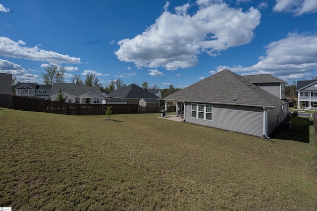 rear view of property with a patio and a lawn