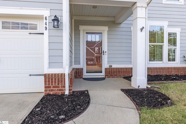 view of exterior entry featuring a garage