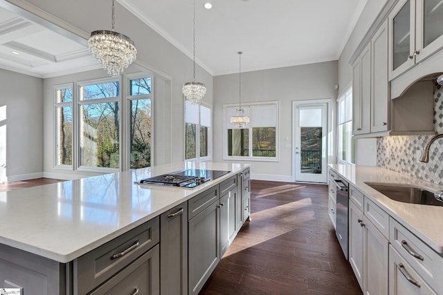 kitchen featuring sink, an inviting chandelier, dark hardwood / wood-style floors, light stone countertops, and appliances with stainless steel finishes