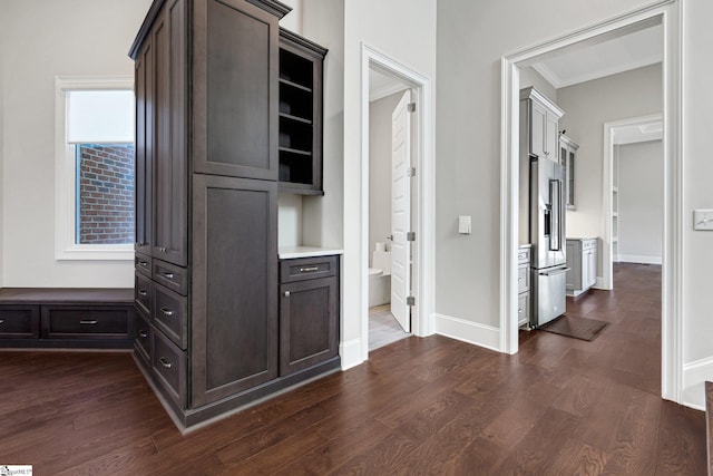 corridor featuring ornamental molding and dark hardwood / wood-style floors