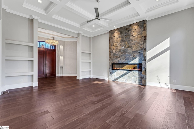 unfurnished living room featuring beamed ceiling, coffered ceiling, a stone fireplace, and built in shelves