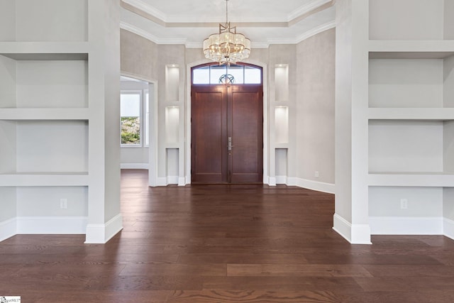 foyer entrance featuring crown molding, a notable chandelier, and dark hardwood / wood-style floors