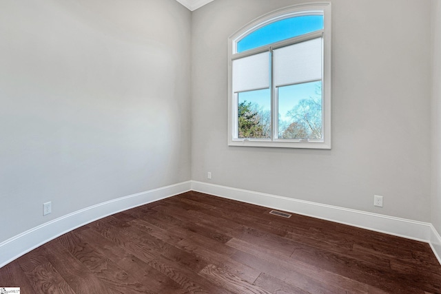 empty room with hardwood / wood-style flooring