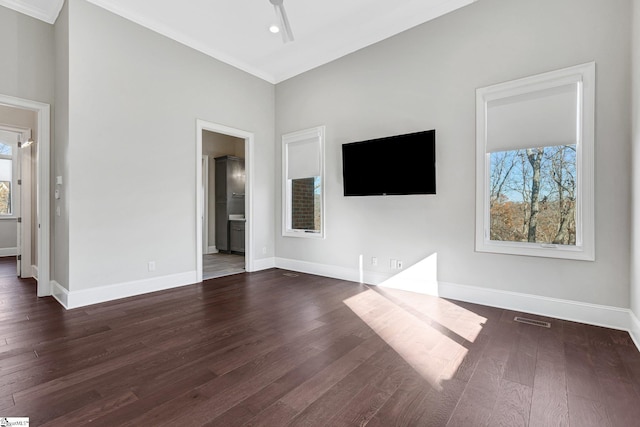 unfurnished living room featuring ceiling fan, crown molding, and dark hardwood / wood-style floors