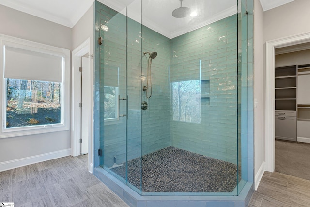 bathroom featuring an enclosed shower and crown molding