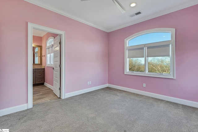 carpeted empty room featuring crown molding