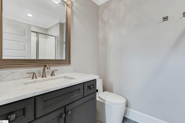 bathroom with crown molding, an enclosed shower, vanity, and toilet