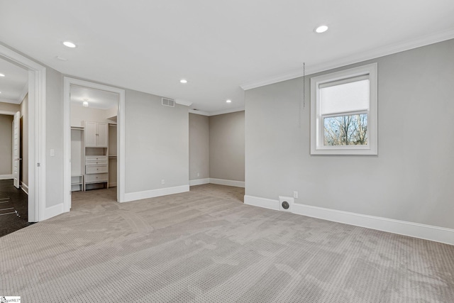 interior space with light colored carpet and crown molding