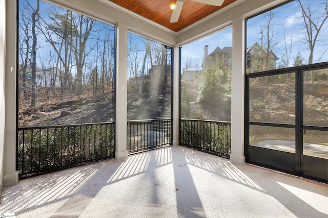 unfurnished sunroom with ceiling fan and wood ceiling