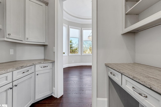 kitchen with white cabinetry, dark hardwood / wood-style floors, and light stone countertops