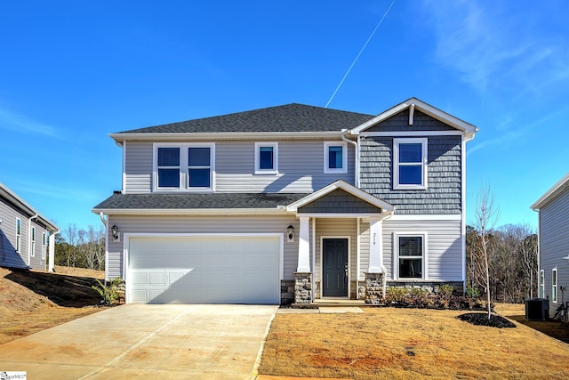 view of front of home featuring central air condition unit and a garage