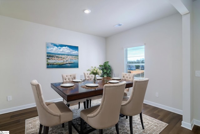 dining space with dark hardwood / wood-style flooring