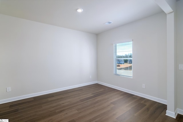 unfurnished room featuring dark wood-type flooring