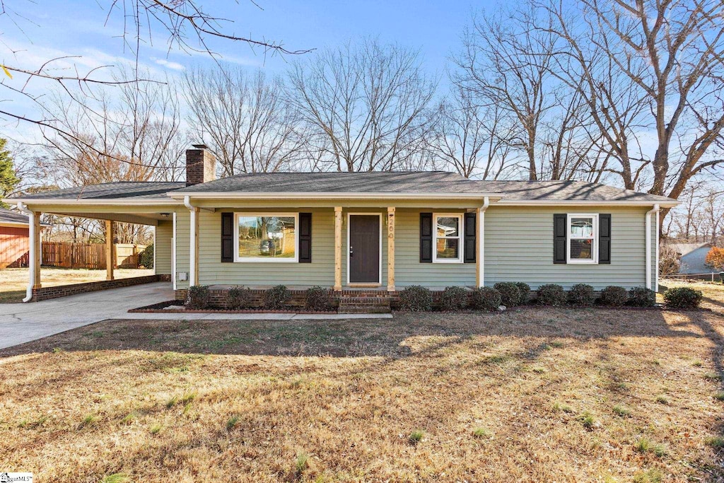 view of front of home with a front yard and a carport