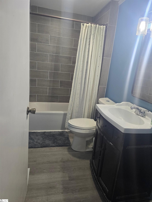 full bathroom featuring toilet, shower / tub combo, vanity, and hardwood / wood-style flooring