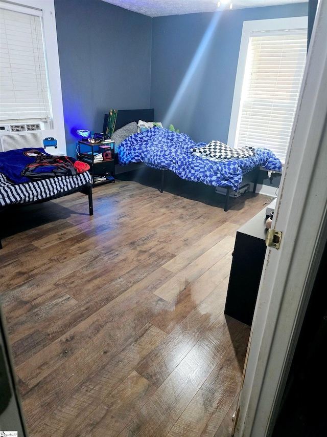 bedroom featuring cooling unit and wood-type flooring