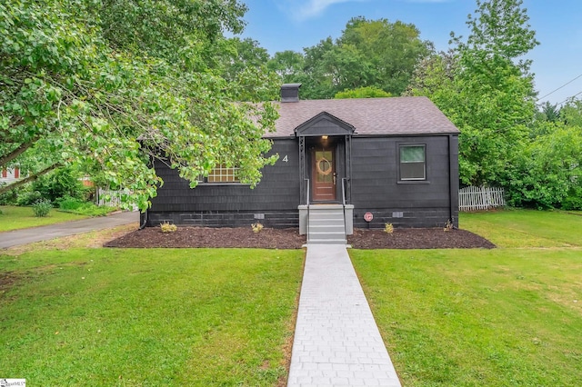 bungalow-style home featuring a front yard