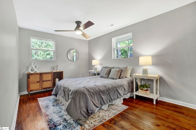 bedroom with dark wood-type flooring and ceiling fan