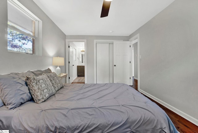 bedroom featuring connected bathroom, hardwood / wood-style floors, and ceiling fan