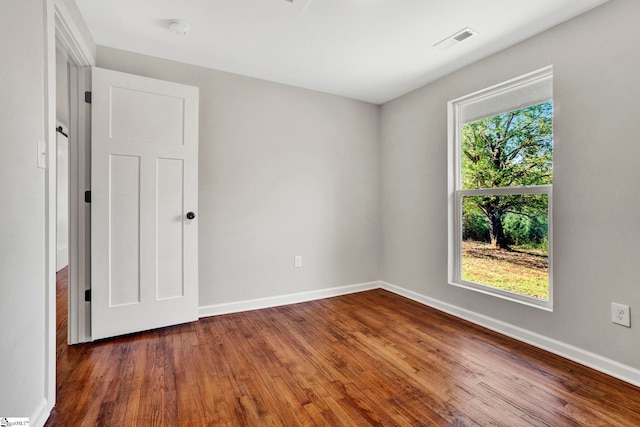 spare room with dark hardwood / wood-style floors