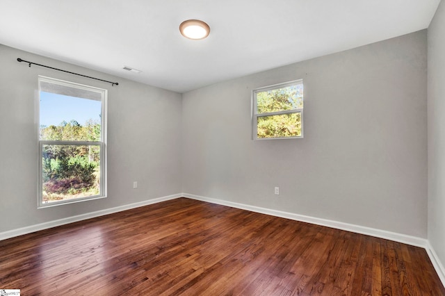 empty room with dark hardwood / wood-style floors