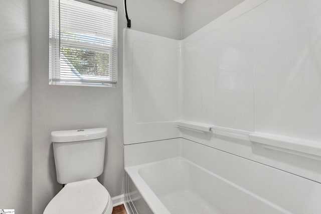 bathroom featuring toilet and a bathing tub