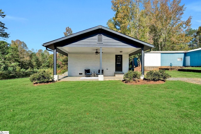 rear view of house with a yard, ceiling fan, and a patio