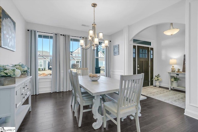 dining room featuring an inviting chandelier and dark hardwood / wood-style floors