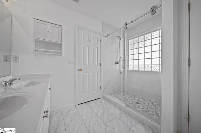 bathroom with vanity and tiled shower