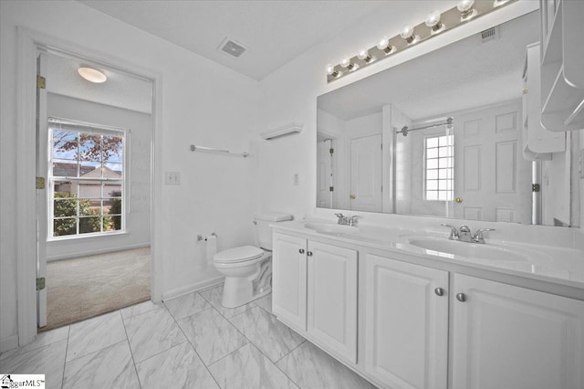 bathroom featuring toilet and vanity