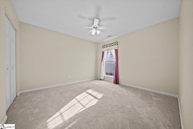 unfurnished bedroom with a closet, ceiling fan, and light carpet