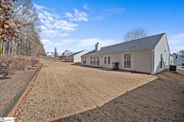 rear view of house featuring central AC