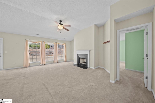 unfurnished living room featuring lofted ceiling, a textured ceiling, light colored carpet, and ceiling fan