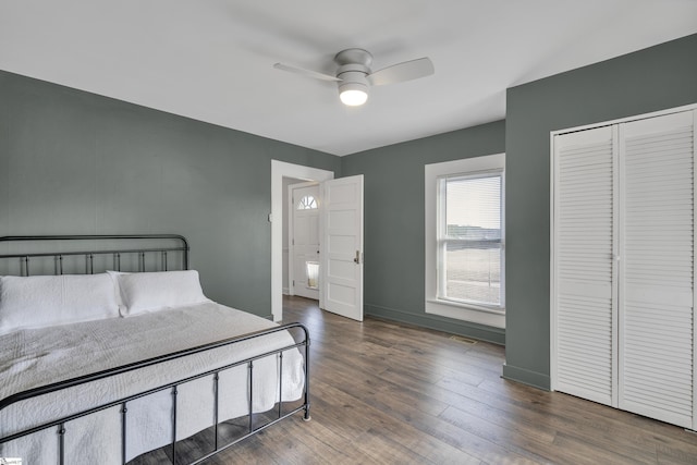 bedroom with ceiling fan and dark hardwood / wood-style floors