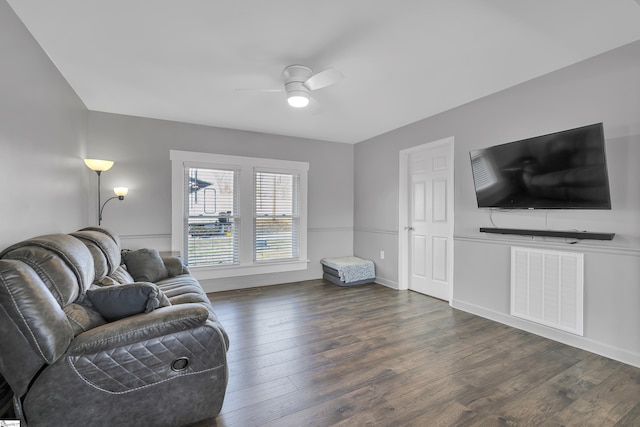 living room featuring ceiling fan and dark hardwood / wood-style floors