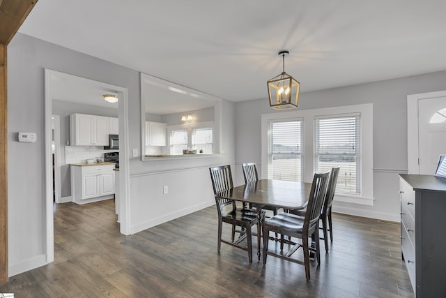 dining space with a notable chandelier and dark wood-type flooring