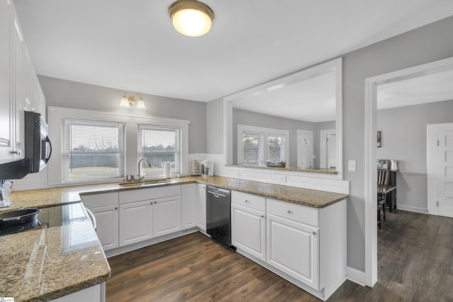 kitchen featuring sink, white cabinetry, dishwashing machine, and stone counters