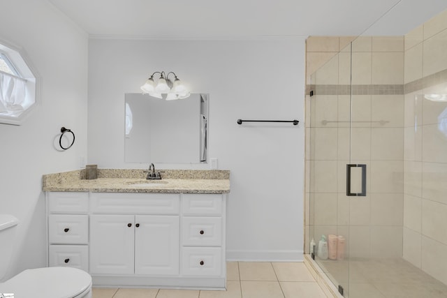 bathroom featuring toilet, tile patterned flooring, vanity, and a shower with shower door