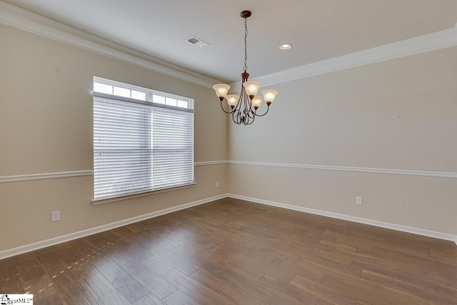 empty room with a notable chandelier, ornamental molding, and dark hardwood / wood-style floors