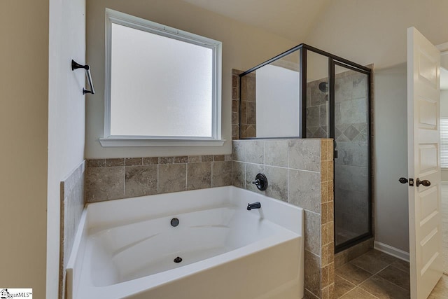 bathroom with tile patterned floors and independent shower and bath