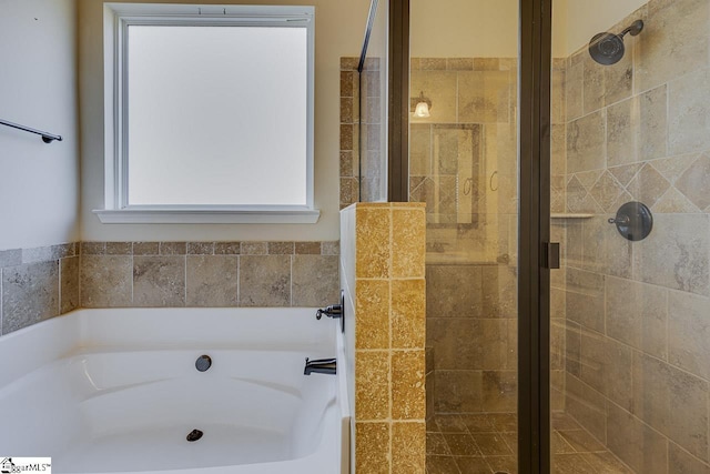 bathroom featuring shower with separate bathtub