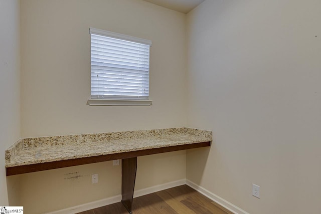 unfurnished office featuring dark hardwood / wood-style flooring