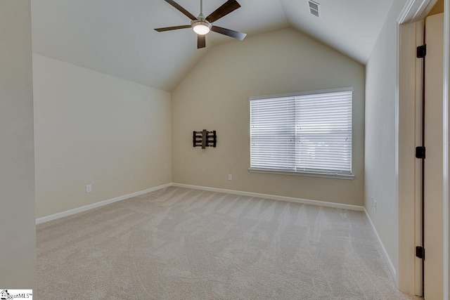 carpeted empty room featuring ceiling fan and lofted ceiling