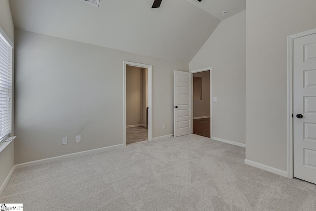 unfurnished bedroom with lofted ceiling, ceiling fan, and light colored carpet